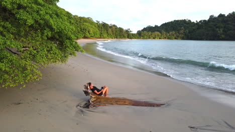 aerial perspective of caucasian female tourist relaxing on the remote beach in costa rica