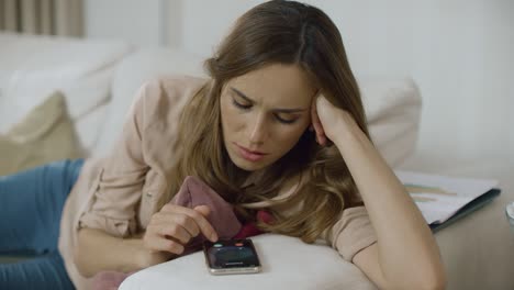 woman answer phone on sofa at home. female person talking mobile on couch