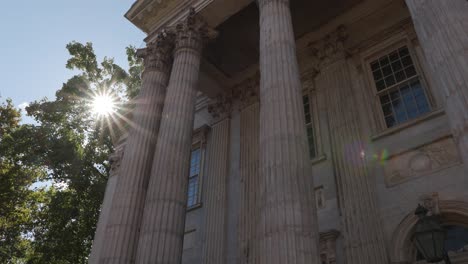 first bank of philadelphia - sun shining through trees in background