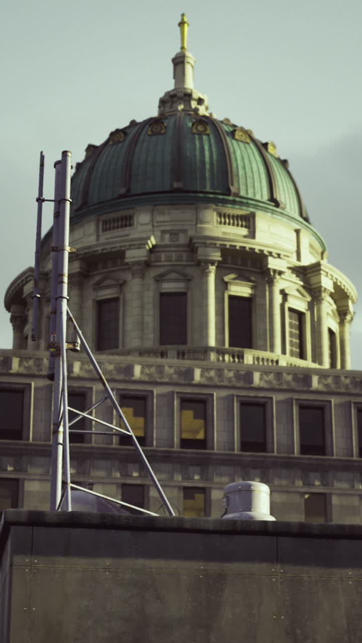 Historic building with dome and antenna at twilight in urban area