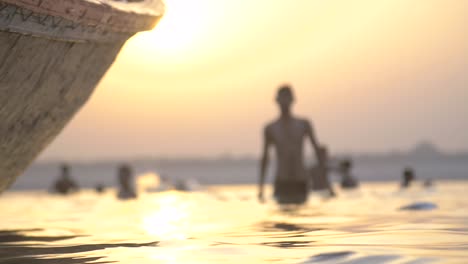 panning shot of man walking in the ganges