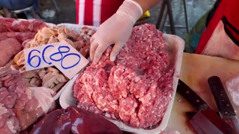 hand arranging ground meat on a tray