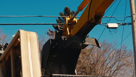 excavator arm and bucket over truck