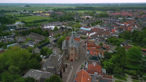 the historic village church of strijen in the netherlands, founded in the 15th century, front and side view