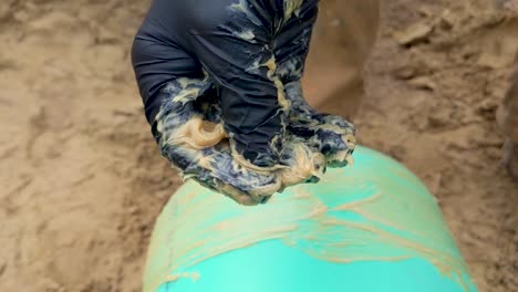 construction worker wearing nitrile gloves rubbing and squishing pipe lube - grease between their fingers