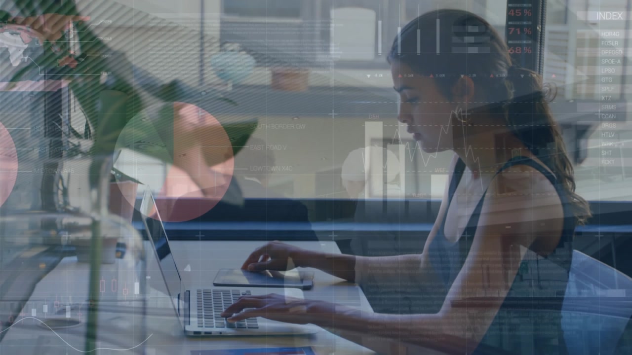 Animation of financial data and graphs over caucasian woman working on laptop in office