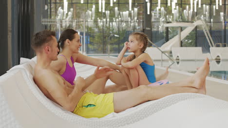 family relaxing by the indoor pool