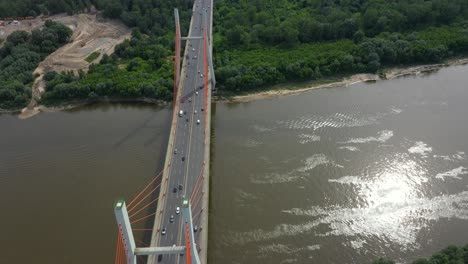 aerial shooting from flying drone car traffic on modern highway bridge over river