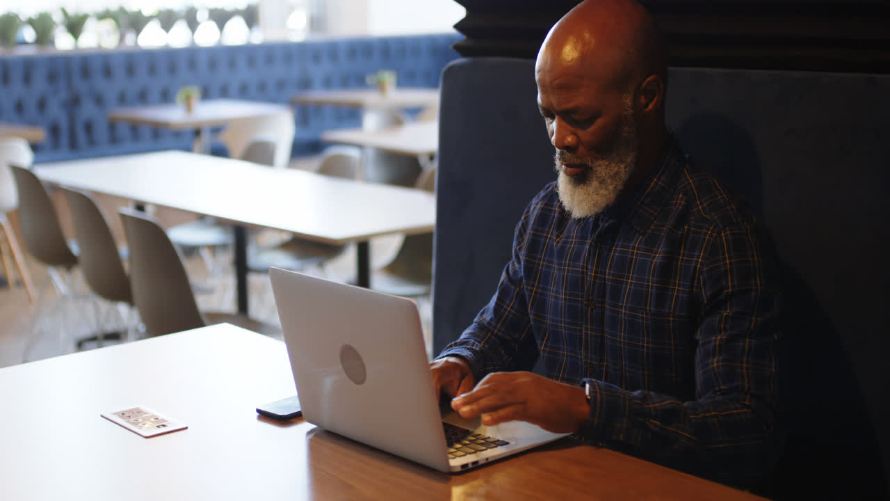 Senior man using laptop in conference room 4k