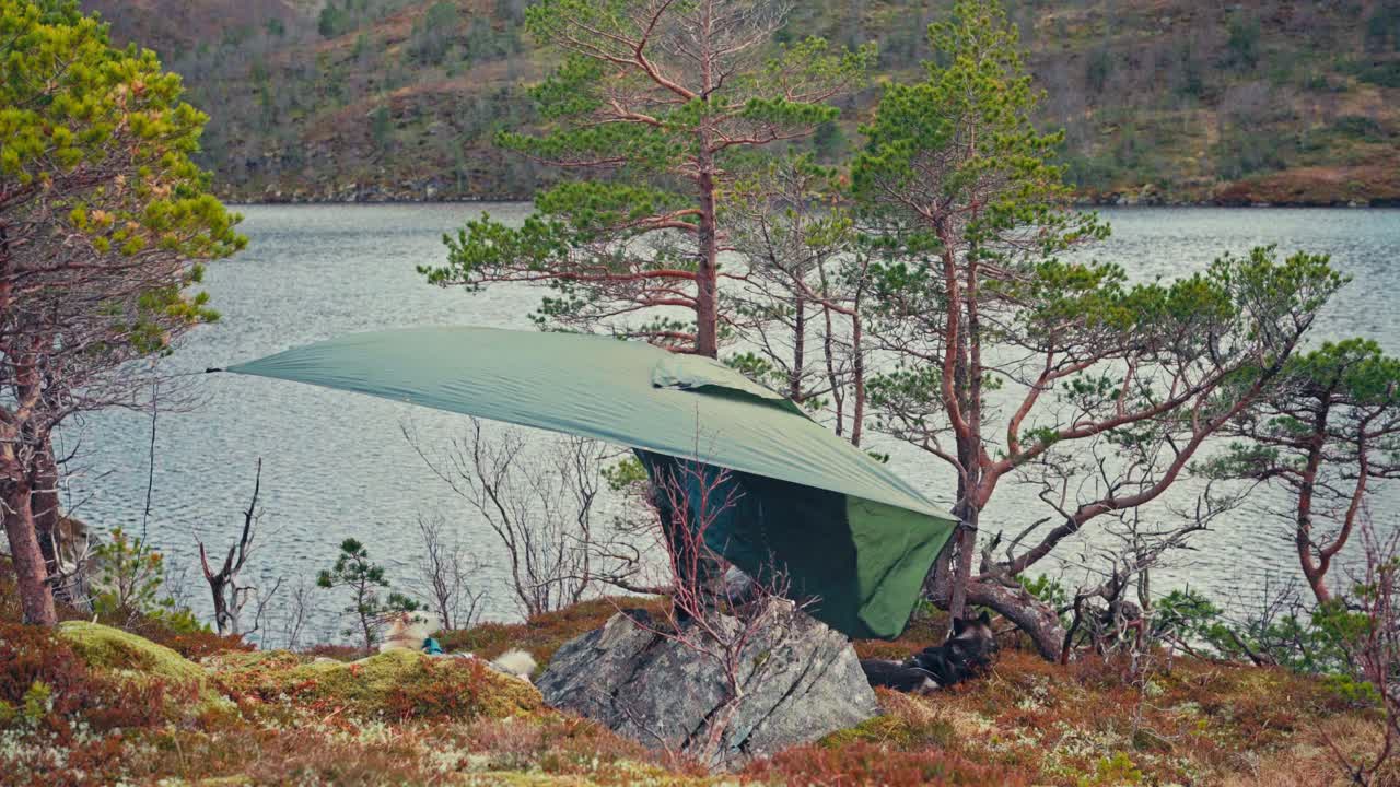 Male Hiker Camping By The Lake In Norway - Wide Shot