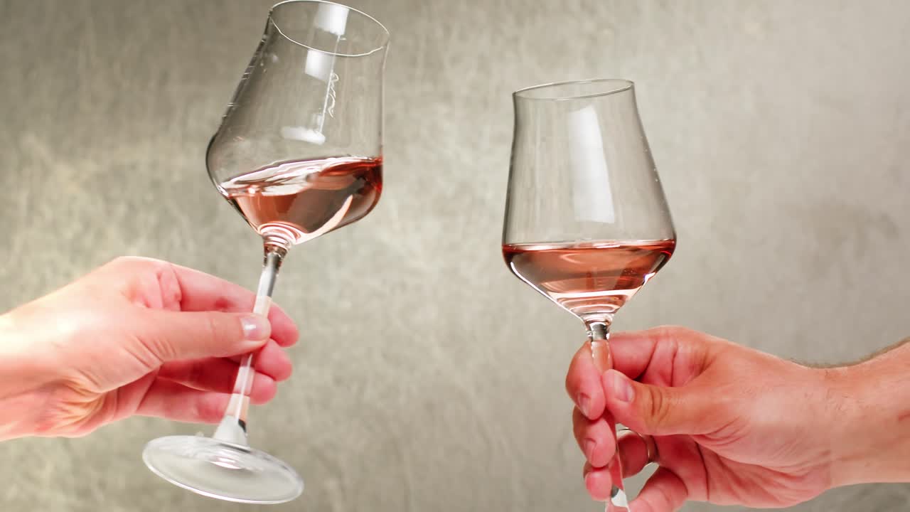 Rose Orange or white wine bottle and glass against a sunset in a peaceful vineyard, pouring of ecological natural wine.