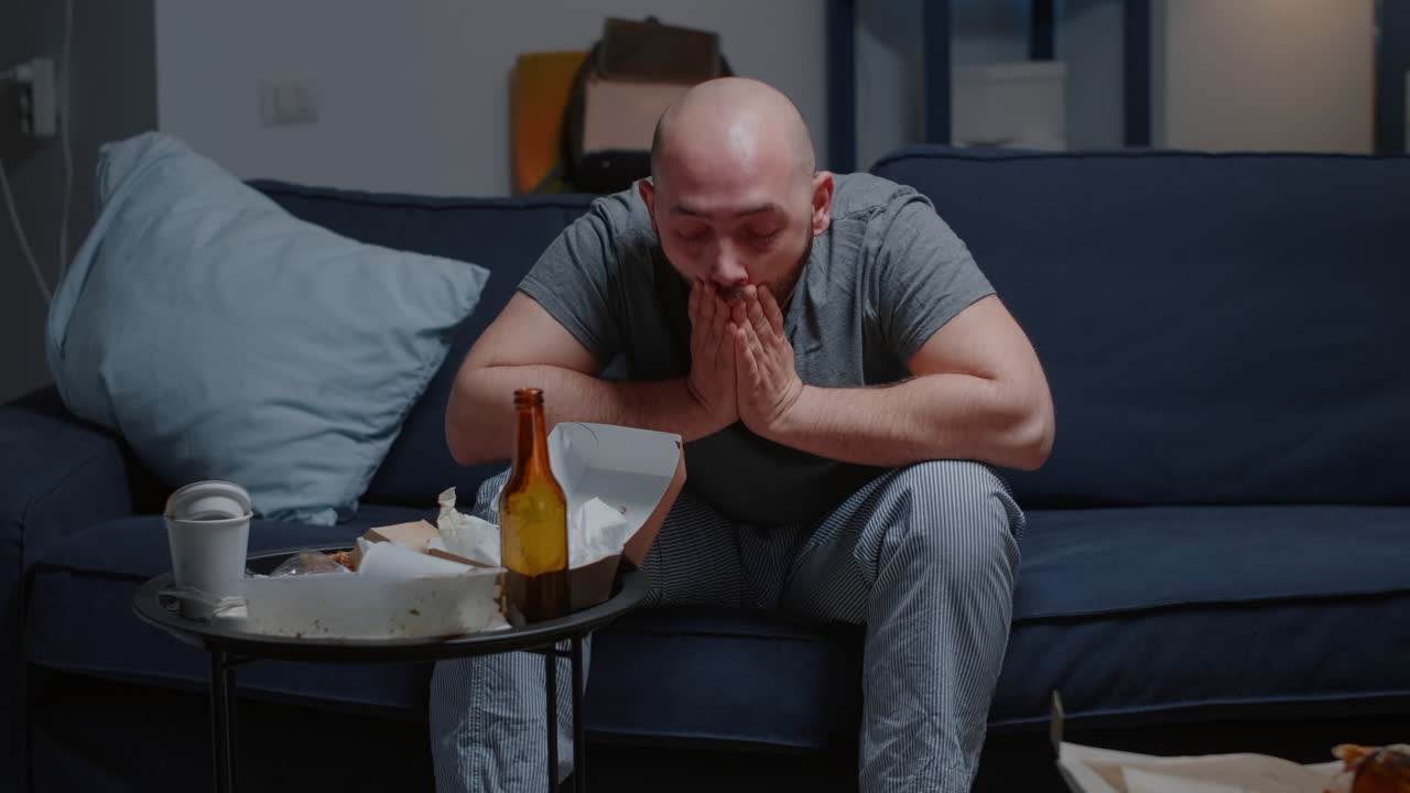 Breakdown depressed worried hopeless man with tears sitting on couch