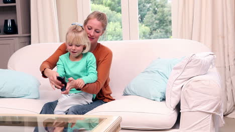 Cute-little-girl-watching-tv-with-her-mother