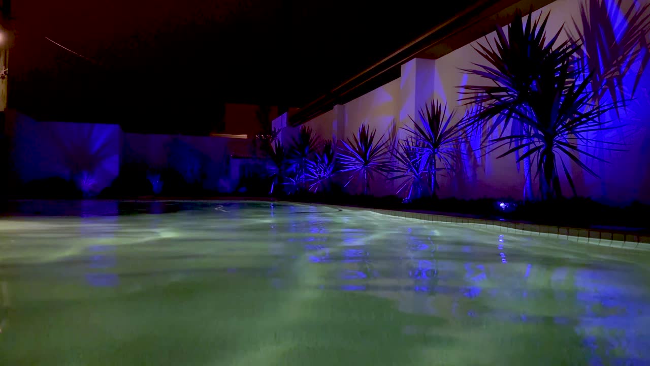 Colorful lights reflecting on a tranquil pool