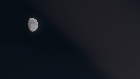 Moon-on-a-dark-summer-night-with-some-grain-moving-slowly-in-the-blurry-foreground