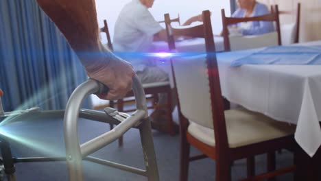 animation of light moving over senior man in dining room using walking frame