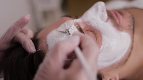 man getting a facial mask treatment