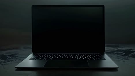 dark laptop with black screen on textured surface