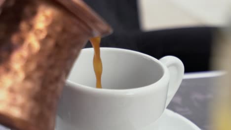 a hot liquid is poured into a mug