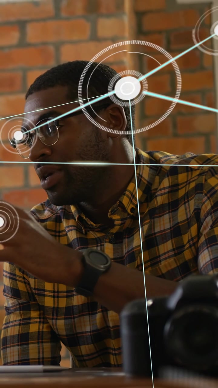 Vertical video: Creative gesturing at DSLR while AR nodes sweeping in from left explaining layout
