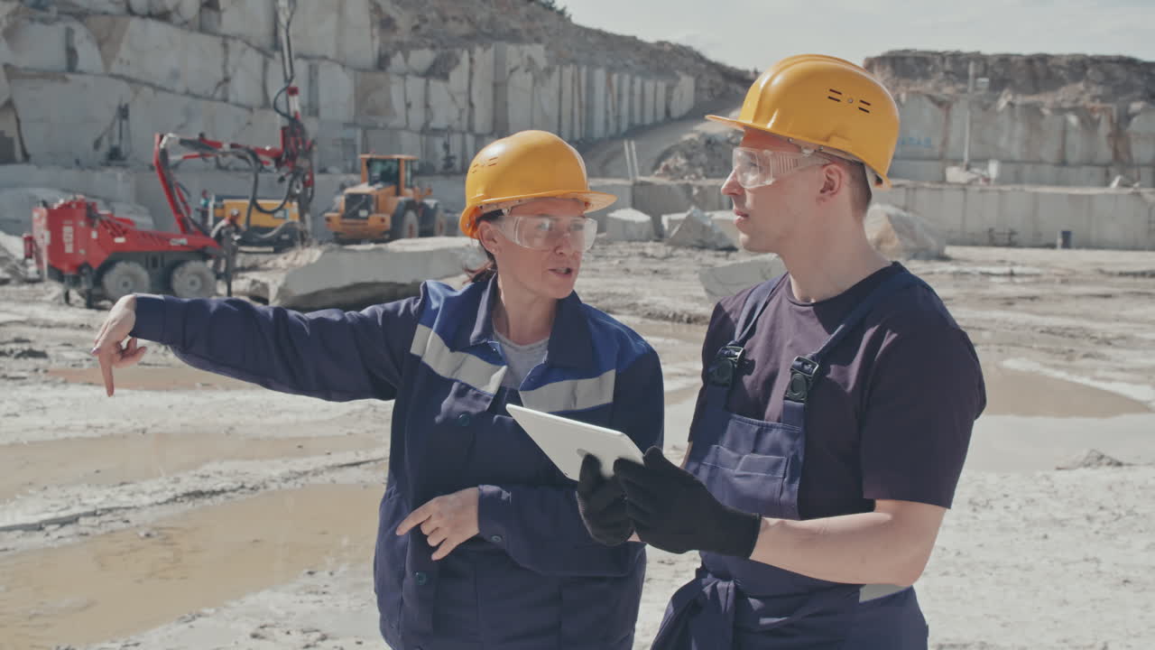 Supervisor Instructing Worker in Granite Quarry