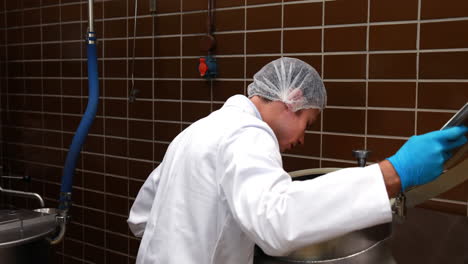 brewery worker checking the product