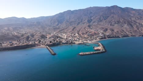 scenic aerial establishment of cedros island harbor, featuring fishing boats docked along a vibrant coastline