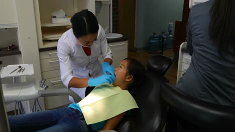 Female-dentist-examining-a-patient-4k