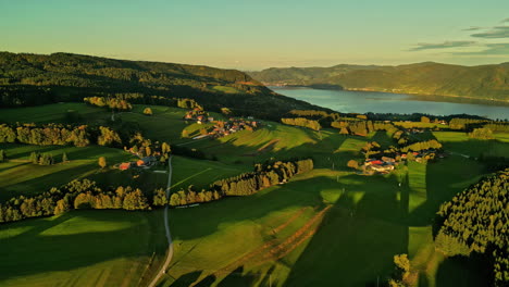 meadows, villages and lake attersee in distance, aerial view