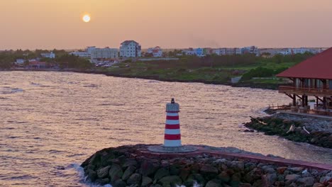 Small lighthouse at sunset by Hilton Garden Inn Hotel at La Romana in Dominican Republic
