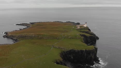 aerial footage of neist point on the isle of skye, scotland, uk. standing at 62ft, neist point is one of the most famous lighthouses in scotland and can be found on the most westerly tip of skye.