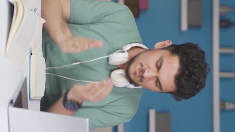 Vertical-video-of-Male-student-having-a-nervous-breakdown.