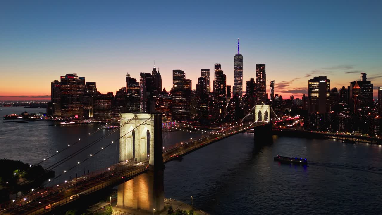 Drone shot of Brooklyn Bridge at dusk with Financial District in the background