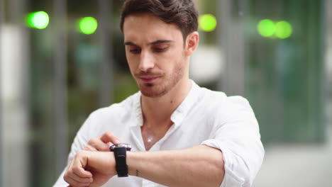 closeup man checking notifications on smart watch. guy using digital watch