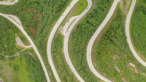 serpentine mountain road with vehicles driving in stryn, vestland, norway