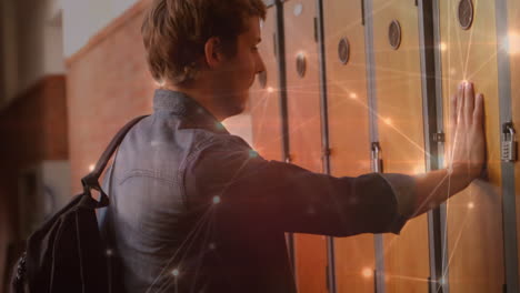 student man opening his locker at school