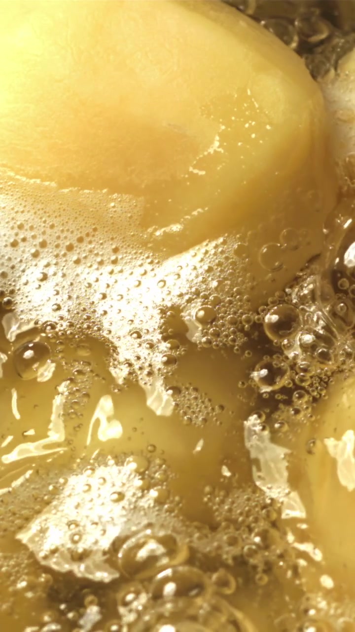 Macro di liquido giallo bollente e schiuma