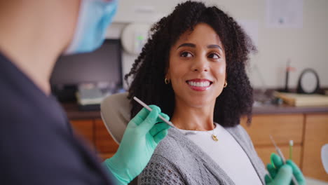 woman talking to dentist during an appointment