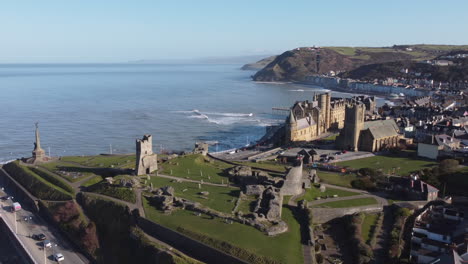 an aerial view of the the welsh town of aberystwyth showing the castle ruin and seafront