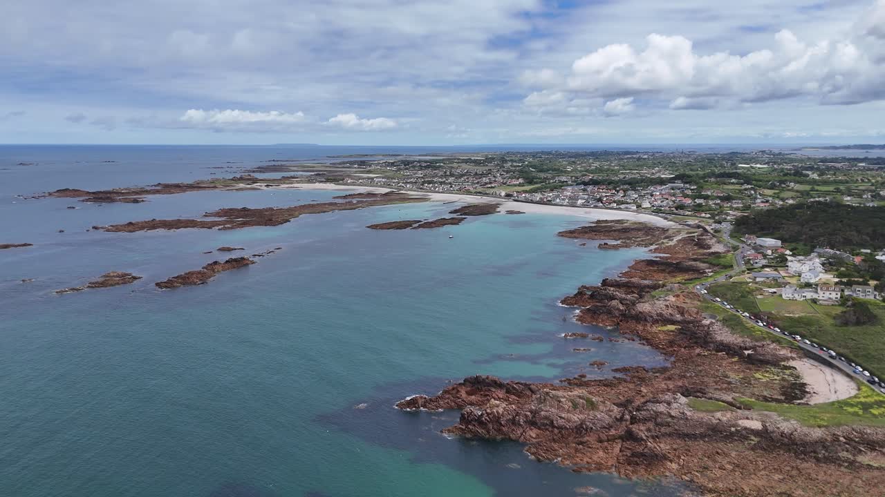 Stunning Aerial View of a Coastal Town and Turquoise Ocean