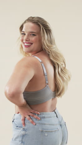 vertical video: smiling plus size woman in casual outfit posing confidently, promoting body positivi