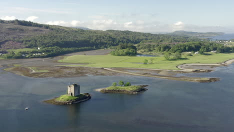 an aerial, high view of castle stalker on loch laich on a sunny morning