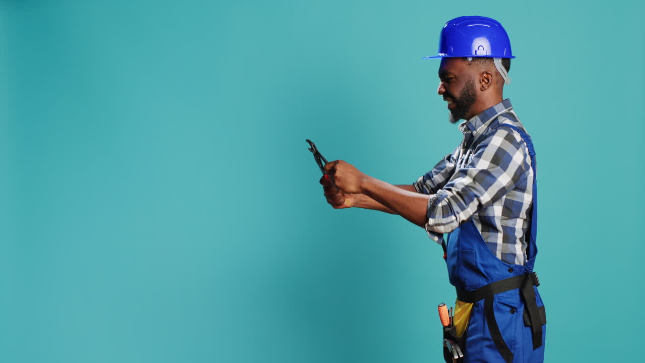 Construction worker clamping something with wrench