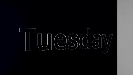 the word "tuesday" on a dark background