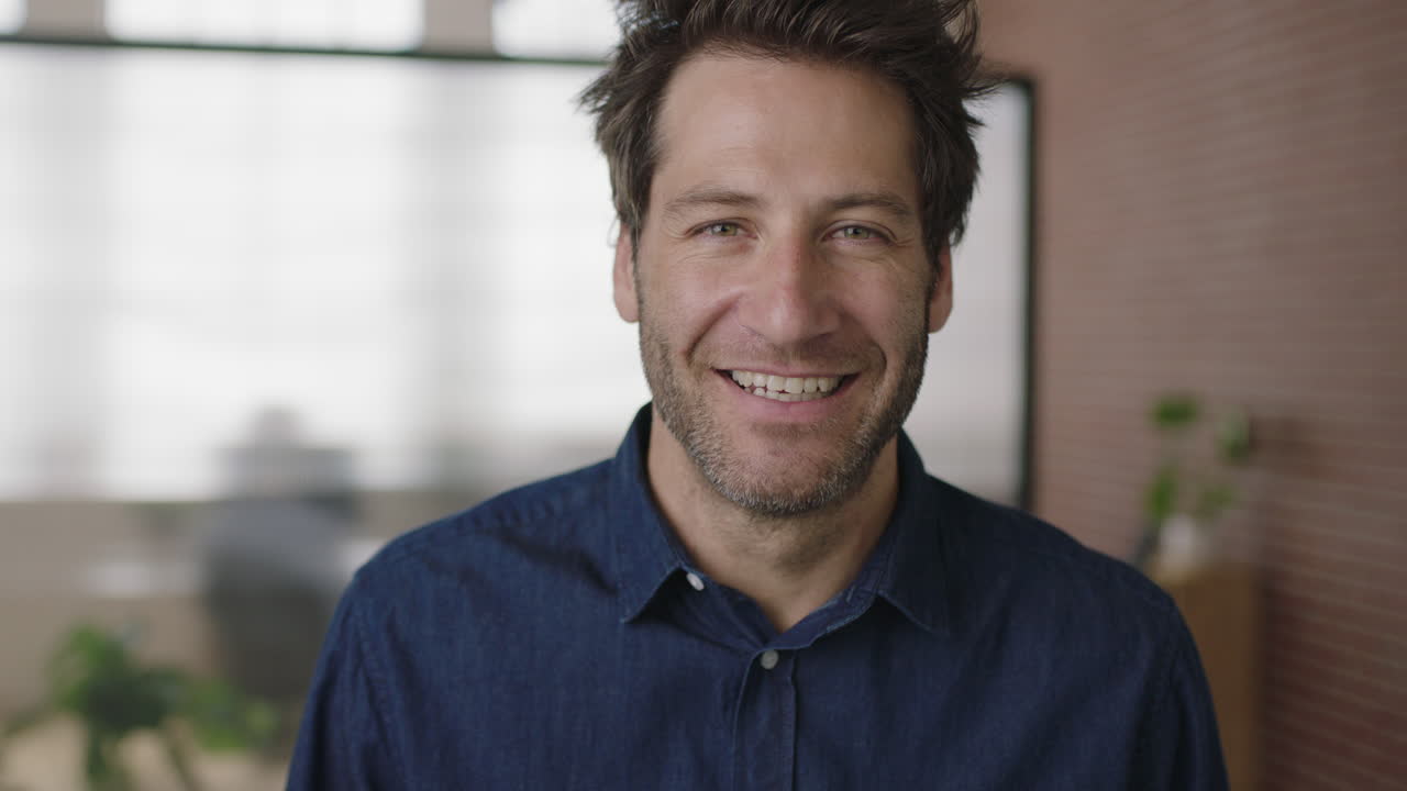 close up portrait of successful young caucasian businessman laughing cheerful enjoying start up business opportunity in modern office workspace