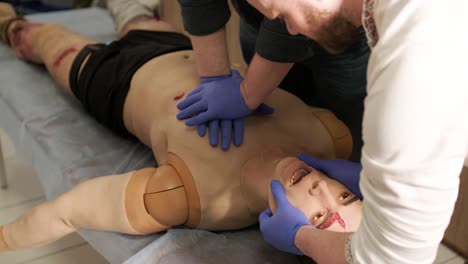 the tactical medic performs artificial respiration and chest compressions on the mannequin.