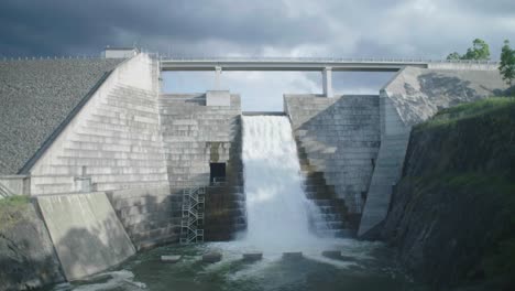 wide shot of a dam water flowing on an overcast day