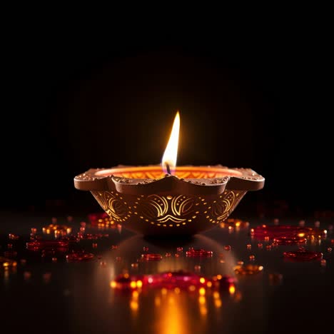 a close-up, low-angle shot of a lit decorative oil lamp on a reflective surface, ideal for festive
