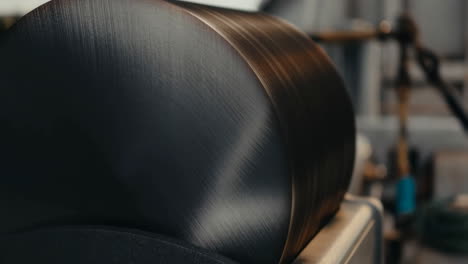 close-up of a large, dark, metallic industrial cylinder or roll