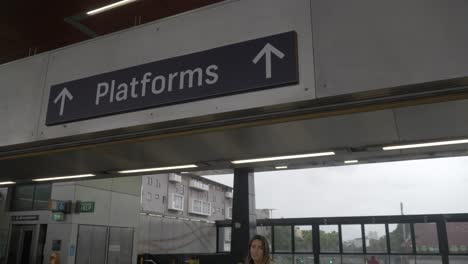 caucasian girl passing through automatic ticket gate - redfern train station - sydney, nsw, australia. - medium shot